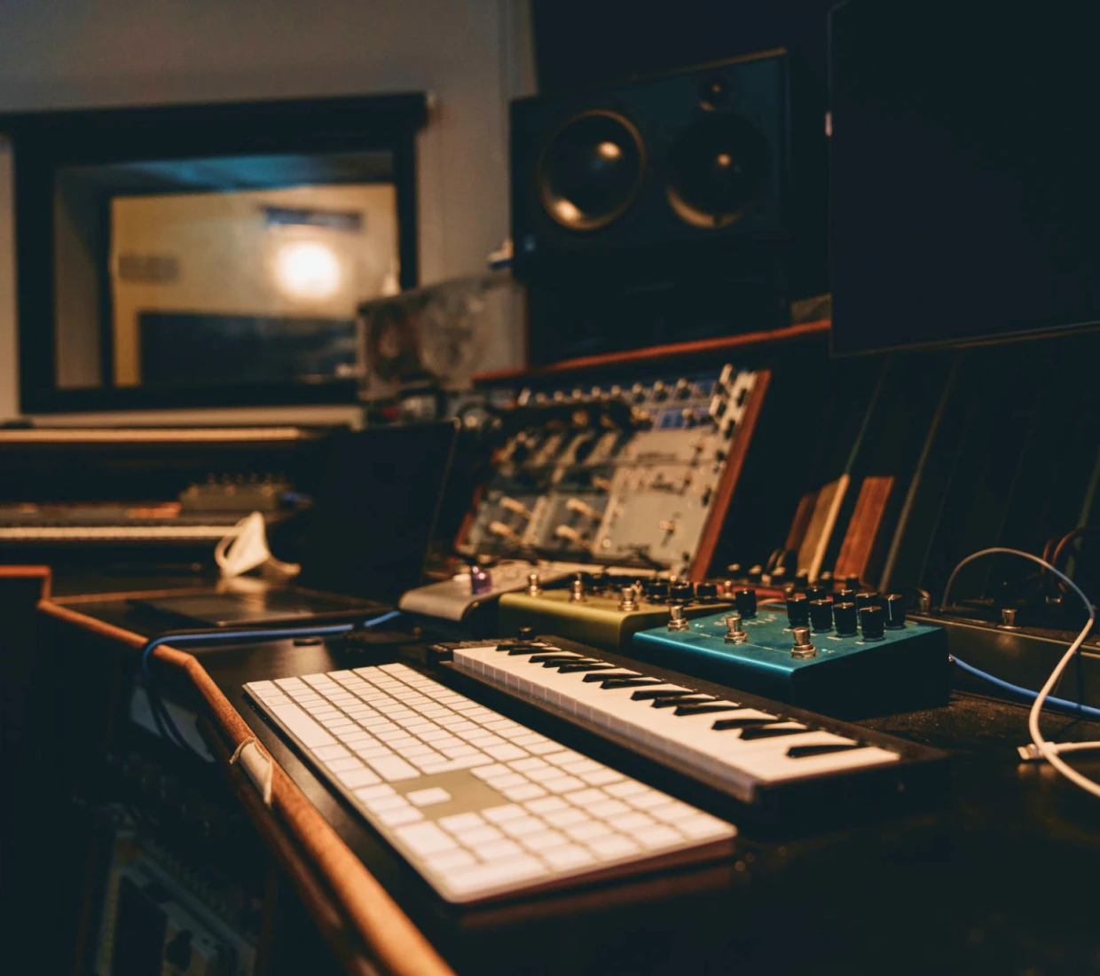 Music studio with synthesizer and speakers