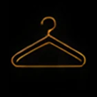Golden clothes hanger on black background.